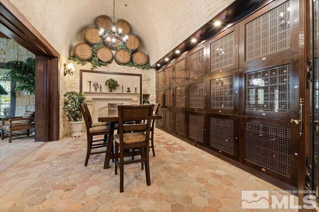 9900 Wilbur May Pkwy Unit 2704, Reno, NV 89521 - wine area featuring stone tile flooring, a chandelier, and vaulted ceiling