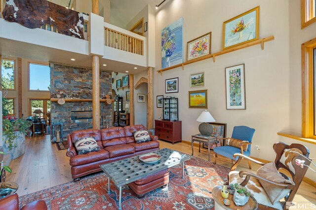 180 Nottingham Ct, Reno, NV 89511 - living area featuring a towering ceiling, hardwood / wood-style floors, and a fireplace