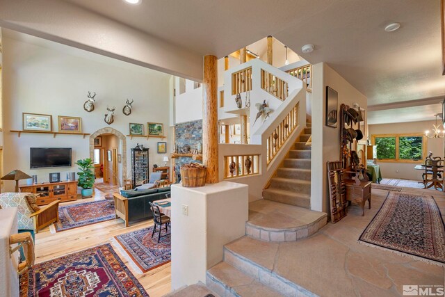 180 Nottingham Ct, Reno, NV 89511 - stairs featuring arched walkways, a chandelier, and wood finished floors