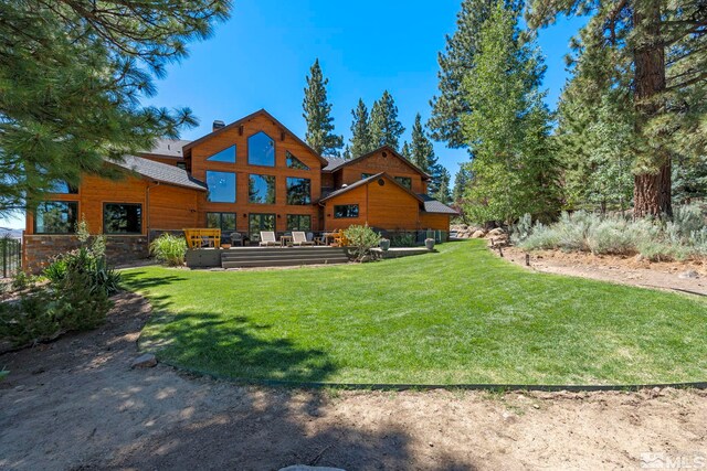 180 Nottingham Ct, Reno, NV 89511 - back of house with a yard, a chimney, and stone siding