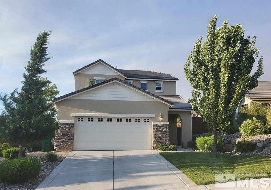 2726 Alessandro Dr, Sparks, NV 89434 - view of front facade with stone siding, driveway, stucco siding, and a garage