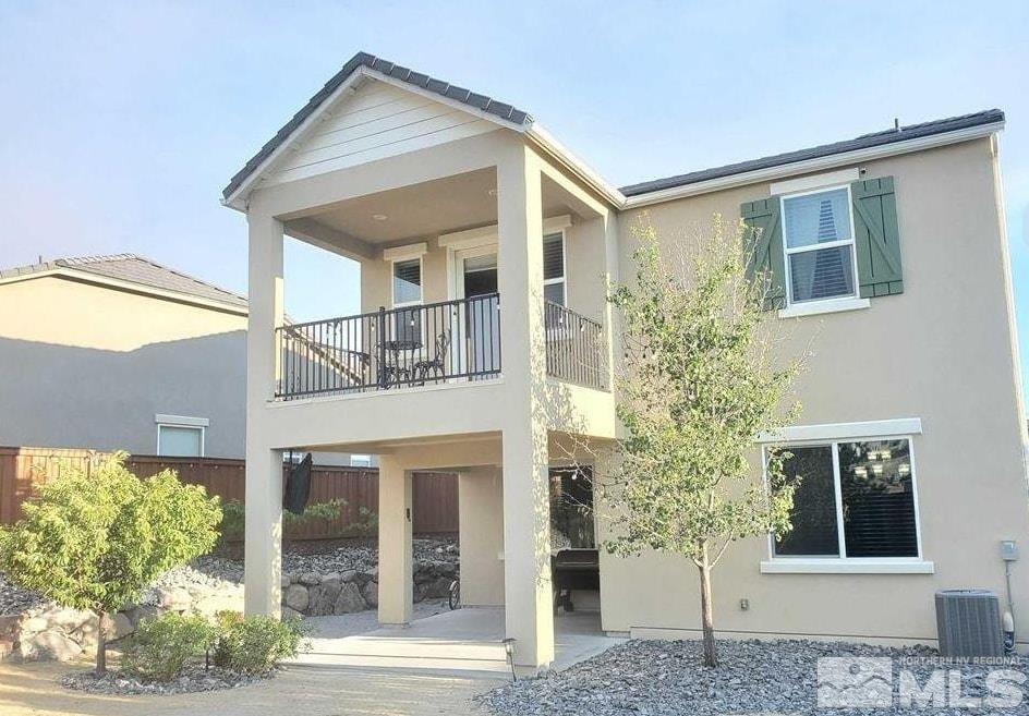 2726 Alessandro Dr, Sparks, NV 89434 - rear view of house featuring stucco siding, fence, a patio, and central AC unit