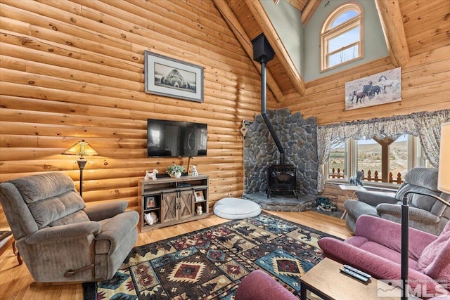 8705 Spearhead Way, Reno, NV 89506 - living area featuring high vaulted ceiling, a wood stove, rustic walls, and hardwood / wood-style flooring