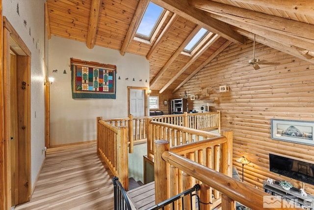 8705 Spearhead Way, Reno, NV 89506 - corridor with an upstairs landing, rustic walls, a skylight, wood ceiling, and beam ceiling