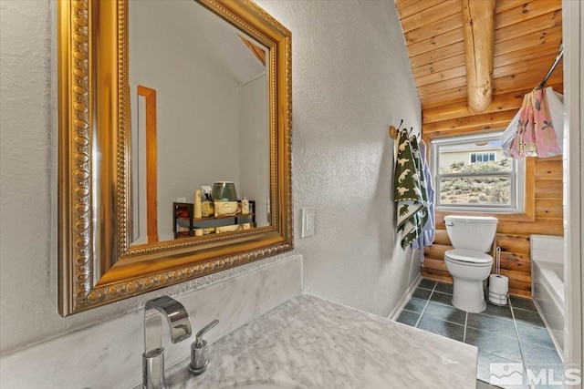 8705 Spearhead Way, Reno, NV 89506 - full bathroom featuring rustic walls, wooden ceiling, toilet, a textured wall, and beam ceiling