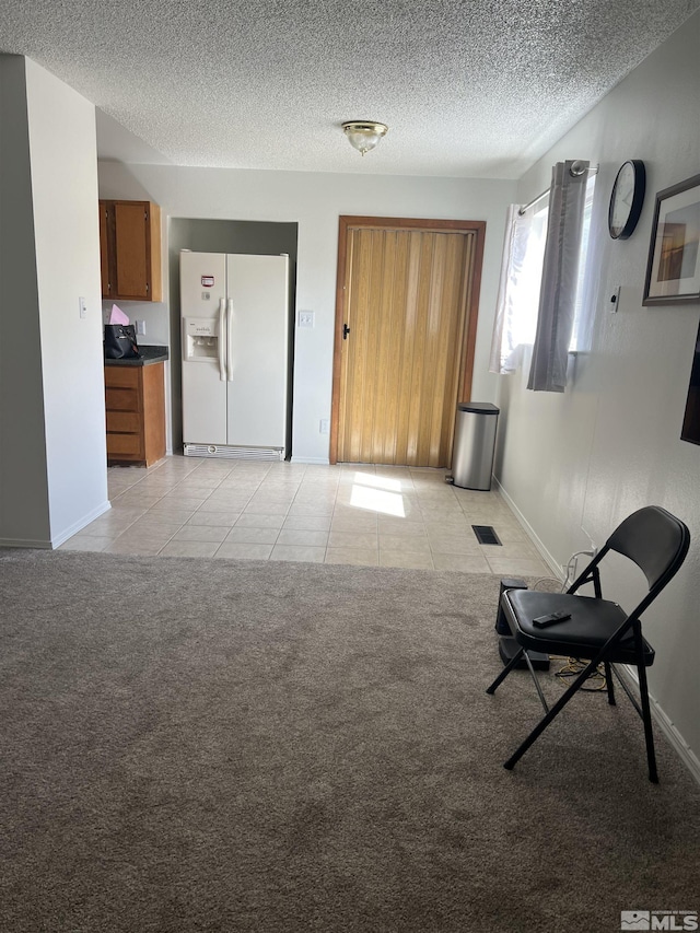 115 Birch St, Hawthorne, NV 89415 - living room with a textured ceiling, baseboards, light tile patterned floors, and light colored carpet