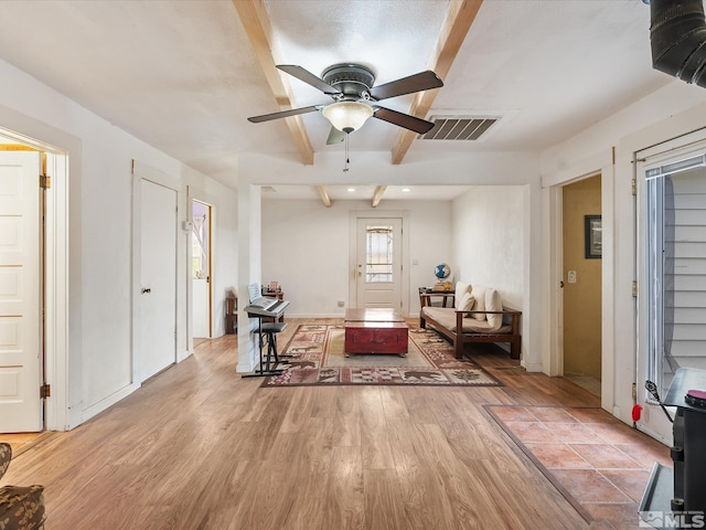325 Stock Ln, Fernley, NV 89408 - living area with beamed ceiling, light wood finished floors, and a ceiling fan
