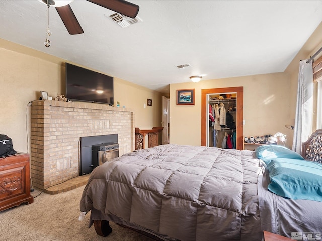 325 Stock Ln, Fernley, NV 89408 - carpeted bedroom with a brick fireplace, a walk in closet, ceiling fan, and a closet