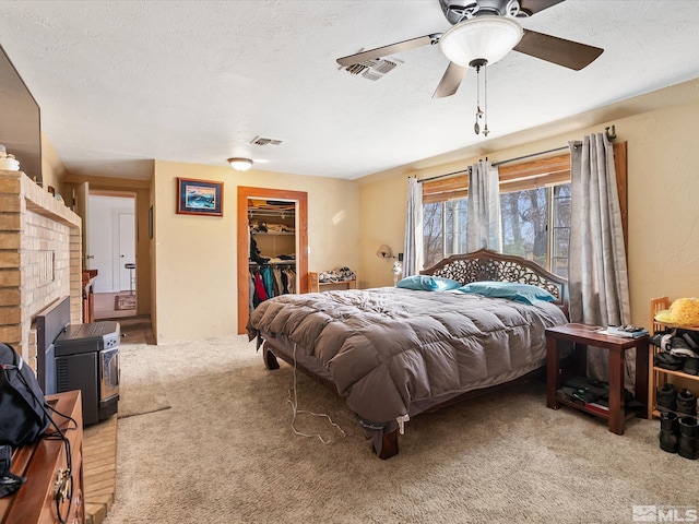 325 Stock Ln, Fernley, NV 89408 - bedroom with light carpet, a walk in closet, ceiling fan, a closet, and a textured ceiling