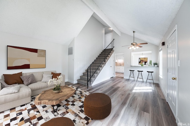 2271 Oppio St, Sparks, NV 89431 - living room featuring stairway, high vaulted ceiling, wood finished floors, a ceiling fan, and beamed ceiling