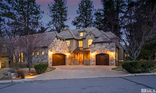 6554 Champetre, Reno, NV 89511 - french provincial home with stone siding, driveway, stucco siding, and an attached garage