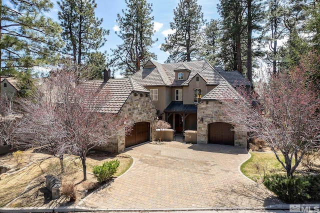 6554 Champetre, Reno, NV 89511 - view of front facade featuring stone siding, stucco siding, and decorative driveway