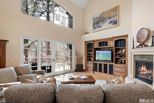 6554 Champetre, Reno, NV 89511 - living area featuring high vaulted ceiling, a glass covered fireplace, and wood finished floors