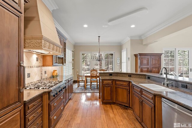 6554 Champetre, Reno, NV 89511 - kitchen featuring appliances with stainless steel finishes, a sink, custom range hood, backsplash, and dark stone counters