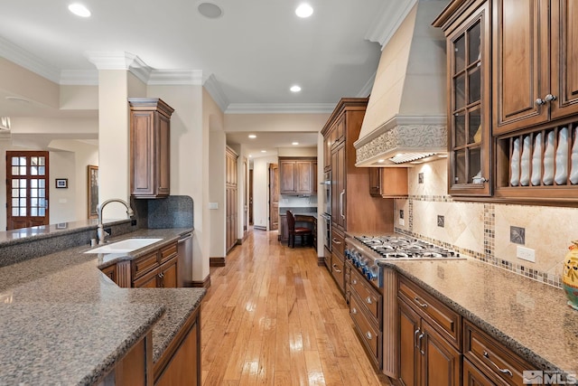 6554 Champetre, Reno, NV 89511 - kitchen featuring custom exhaust hood, appliances with stainless steel finishes, a sink, dark stone countertops, and brown cabinets