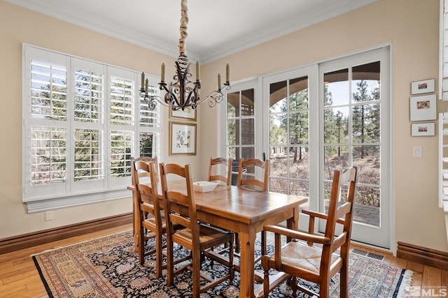 6554 Champetre, Reno, NV 89511 - dining room featuring healthy amount of natural light, a chandelier, hardwood / wood-style floors, and crown molding