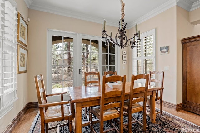 6554 Champetre, Reno, NV 89511 - dining area featuring a chandelier, plenty of natural light, light wood-style flooring, and ornamental molding