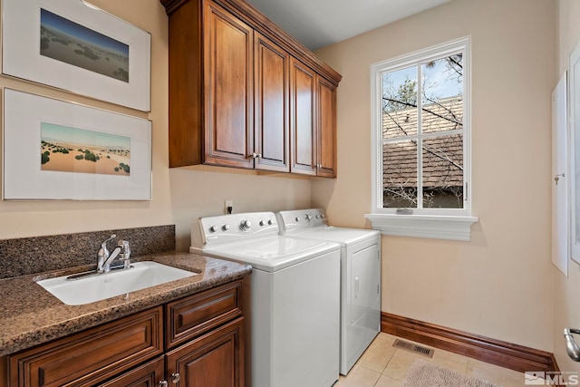 6554 Champetre, Reno, NV 89511 - washroom featuring cabinet space, washing machine and dryer, light tile patterned floors, and baseboards