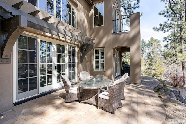 6554 Champetre, Reno, NV 89511 - view of patio with a pergola, a balcony, outdoor dining area, and french doors