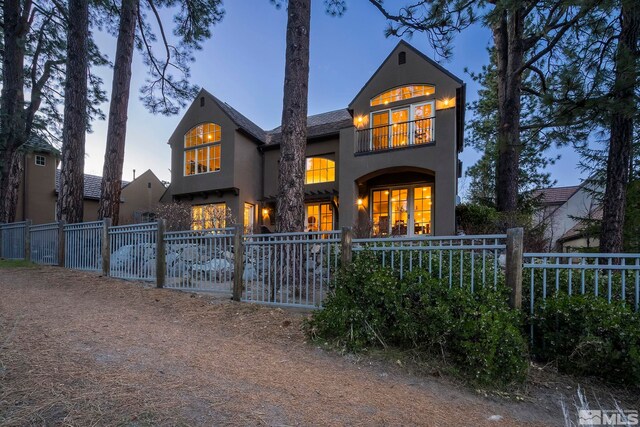 6554 Champetre, Reno, NV 89511 - rear view of house featuring stucco siding, a fenced front yard, and a gate