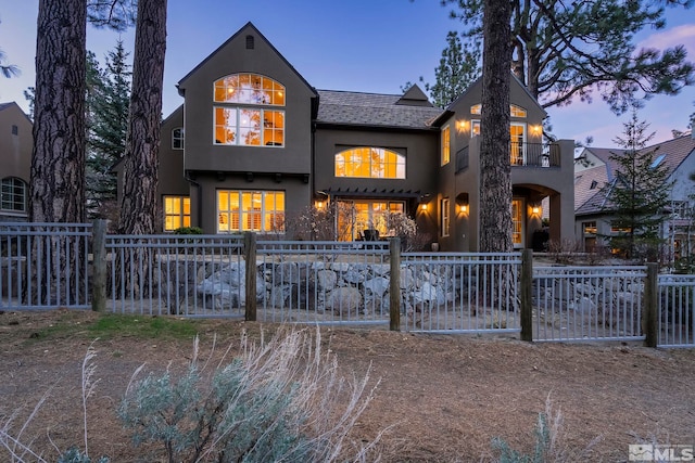 6554 Champetre, Reno, NV 89511 - rear view of house featuring stucco siding, a fenced front yard, and a balcony