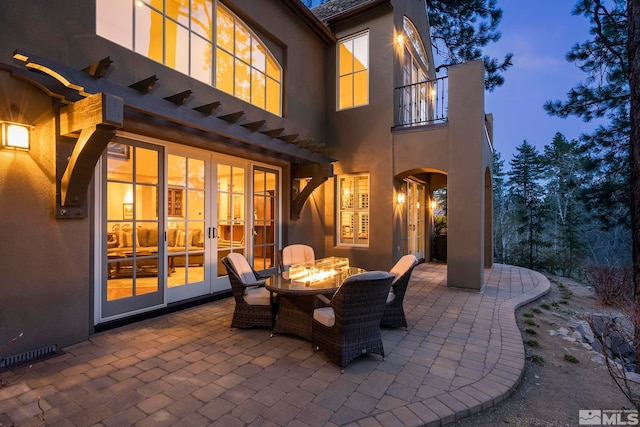 6554 Champetre, Reno, NV 89511 - view of patio with a balcony, french doors, and an outdoor fire pit