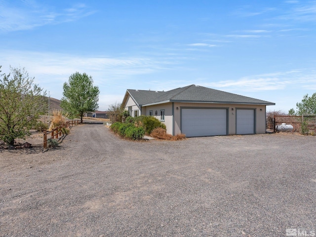1974 Spring Rd, Fernley, NV 89408 - view of front facade featuring a garage, driveway, and stucco siding