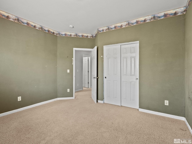 1974 Spring Rd, Fernley, NV 89408 - unfurnished bedroom with light colored carpet, baseboards, and a closet