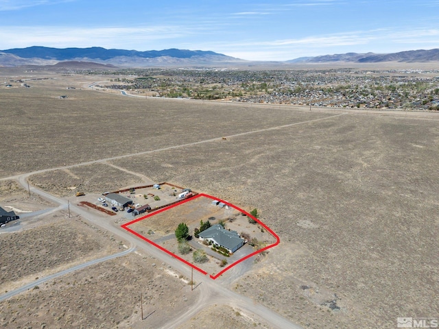 1974 Spring Rd, Fernley, NV 89408 - aerial view of sparsely populated area featuring mountains, property parcel outlined, and a desert landscape