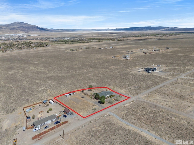 1974 Spring Rd, Fernley, NV 89408 - aerial view of sparsely populated area featuring a mountainous background, property boundaries highlighted, and a desert landscape