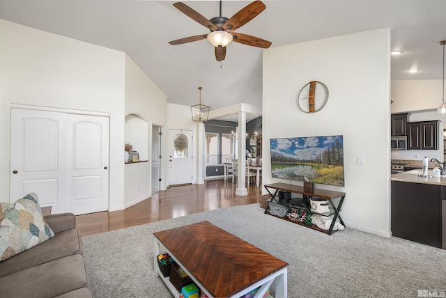1675 Skyridge Dr, Fallon, NV 89406 - living area featuring ceiling fan, high vaulted ceiling, baseboards, and carpet flooring