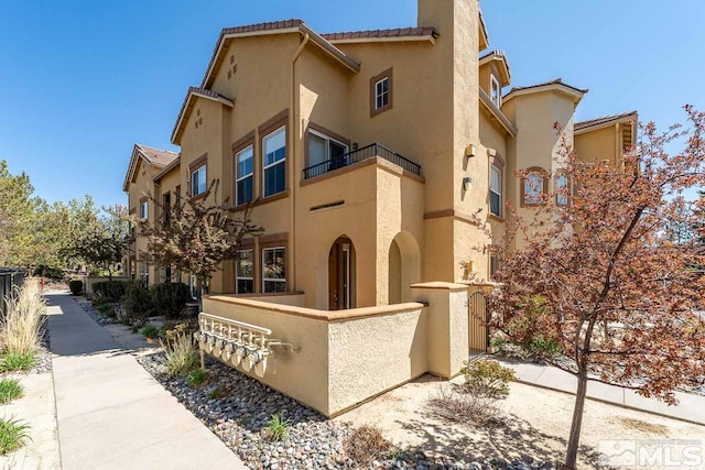 17000 Wedge Pkwy Unit 111, Reno, NV 89511 - view of front facade with stucco siding and a balcony