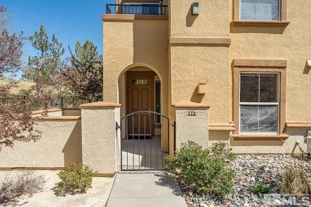 17000 Wedge Pkwy Unit 111, Reno, NV 89511 - entrance to property with a gate, fence, and stucco siding