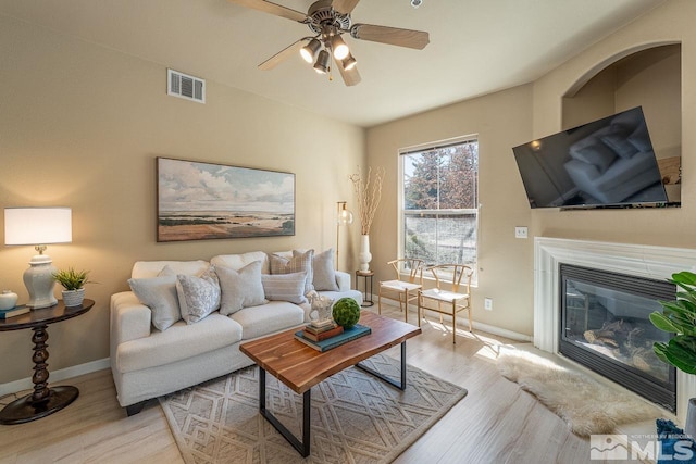 17000 Wedge Pkwy Unit 111, Reno, NV 89511 - living area featuring wood finished floors, baseboards, a ceiling fan, and a glass covered fireplace