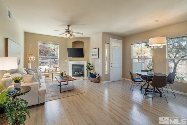 17000 Wedge Pkwy Unit 111, Reno, NV 89511 - living room featuring wood finished floors, baseboards, ceiling fan, and a glass covered fireplace