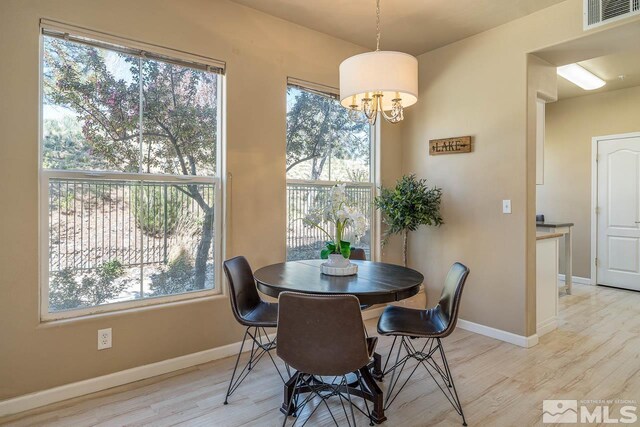 17000 Wedge Pkwy Unit 111, Reno, NV 89511 - dining space featuring light wood-style floors, baseboards, and a chandelier
