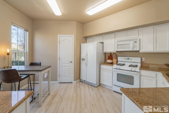 17000 Wedge Pkwy Unit 111, Reno, NV 89511 - kitchen with white appliances, light wood-type flooring, white cabinetry, and baseboards