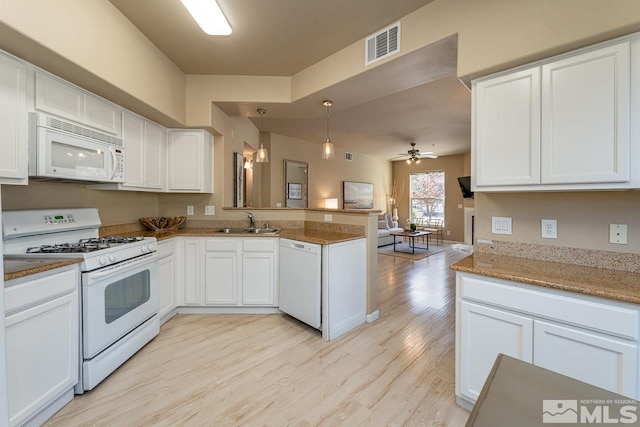 17000 Wedge Pkwy Unit 111, Reno, NV 89511 - kitchen with white appliances, a sink, a peninsula, light wood-type flooring, and open floor plan