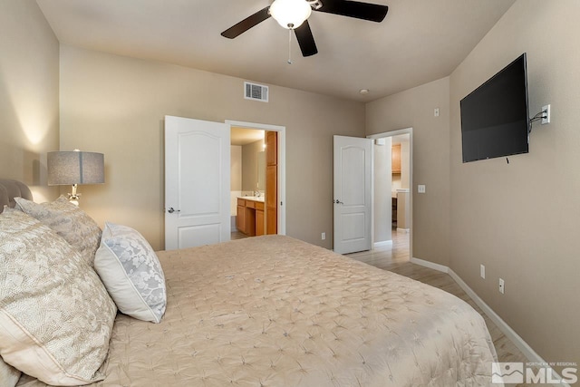 17000 Wedge Pkwy Unit 111, Reno, NV 89511 - bedroom featuring baseboards, wood finished floors, ceiling fan, and connected bathroom