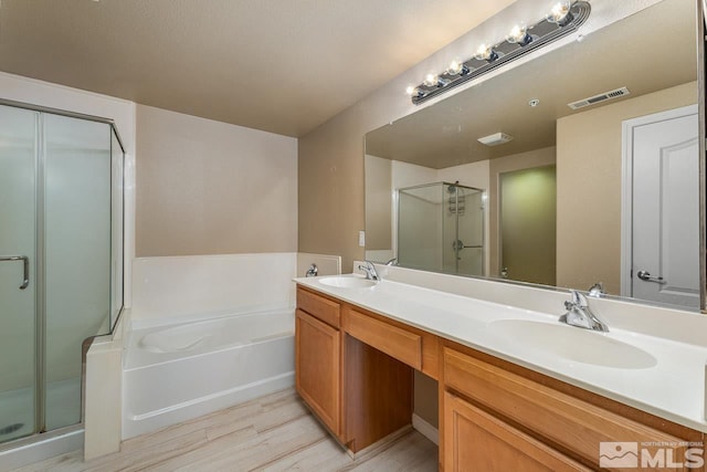 17000 Wedge Pkwy Unit 111, Reno, NV 89511 - bathroom featuring wood finished floors, a stall shower, a garden tub, and double vanity