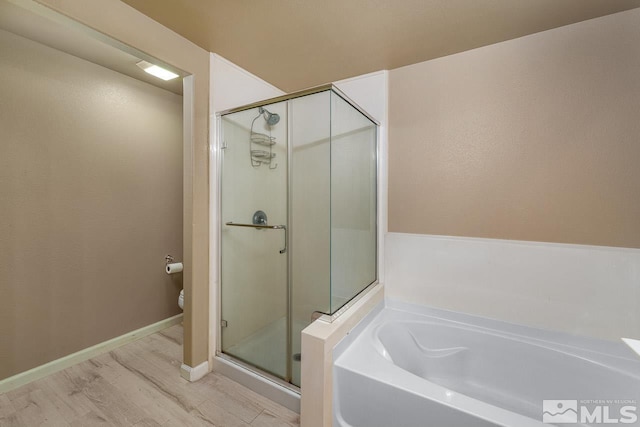 17000 Wedge Pkwy Unit 111, Reno, NV 89511 - bathroom featuring a shower stall, wood finished floors, a garden tub, and toilet