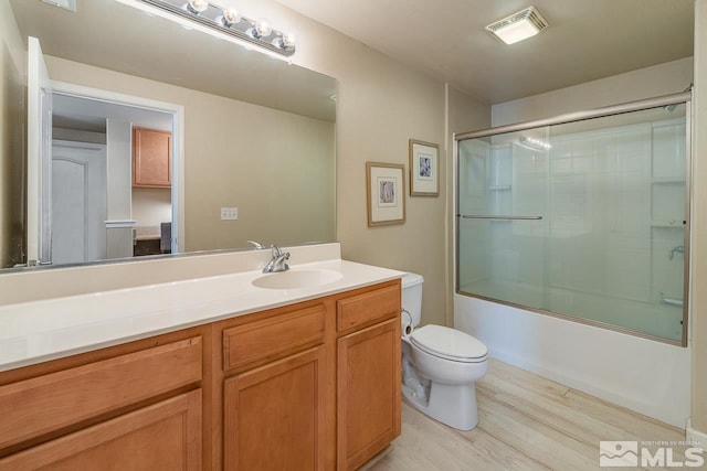 17000 Wedge Pkwy Unit 111, Reno, NV 89511 - bathroom with wood finished floors, toilet, vanity, and shower / bath combination with glass door