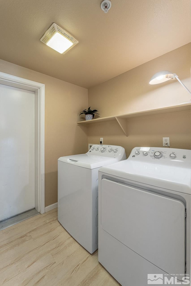 17000 Wedge Pkwy Unit 111, Reno, NV 89511 - laundry area featuring washing machine and dryer and light wood-style floors