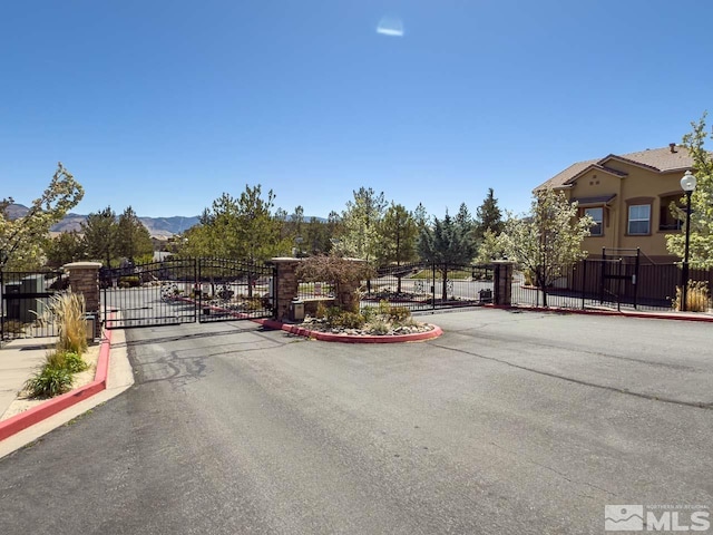17000 Wedge Pkwy Unit 111, Reno, NV 89511 - view of asphalt street featuring a gate, a gated entry, and curbs