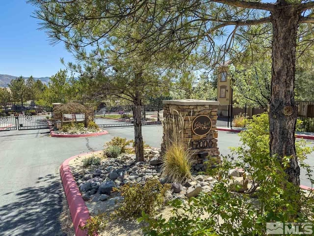 17000 Wedge Pkwy Unit 111, Reno, NV 89511 - community / neighborhood sign featuring a gate, fence, and a mountain view
