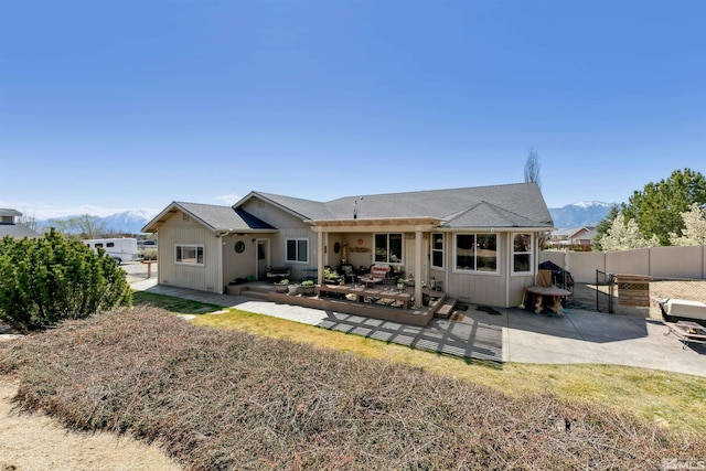 1367 Porter Dr, Minden, NV 89423 - rear view of property featuring a mountain view, fence, a patio, and board and batten siding