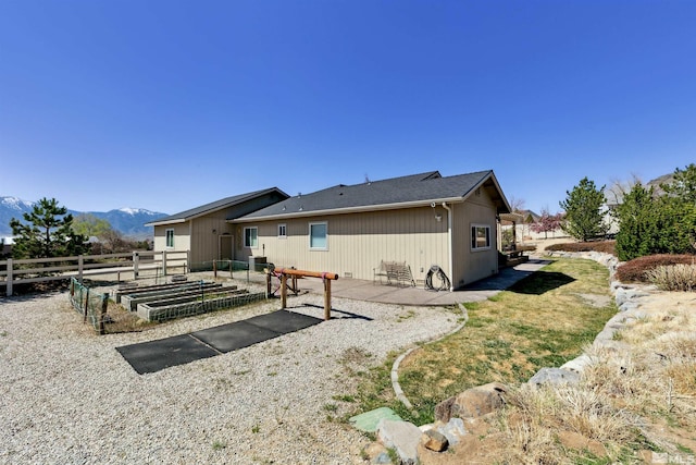 1367 Porter Dr, Minden, NV 89423 - rear view of house featuring a vegetable garden, fence, a patio, and a mountain view