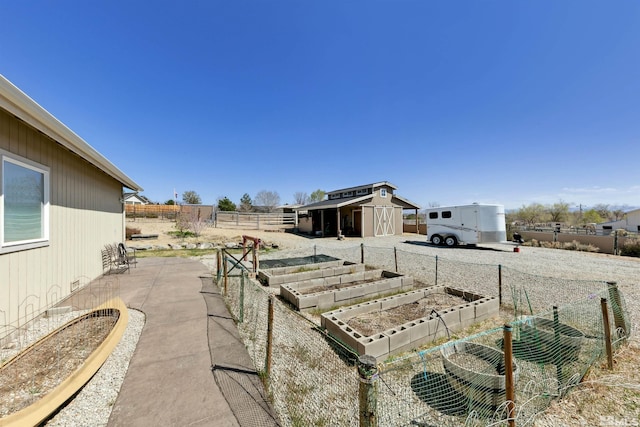 1367 Porter Dr, Minden, NV 89423 - view of yard featuring a garden, fence, and an outdoor structure
