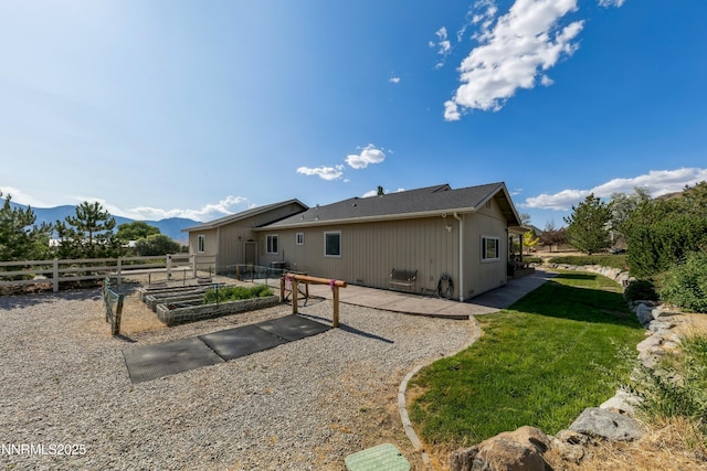 1367 Porter Dr, Minden, NV 89423 - back of house featuring a vegetable garden and a mountain view