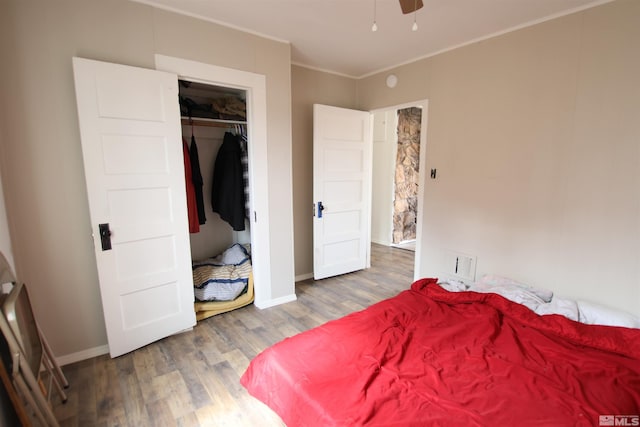 665 C St, Hawthorne, NV 89415 - bedroom with wood finished floors, a closet, baseboards, and ornamental molding